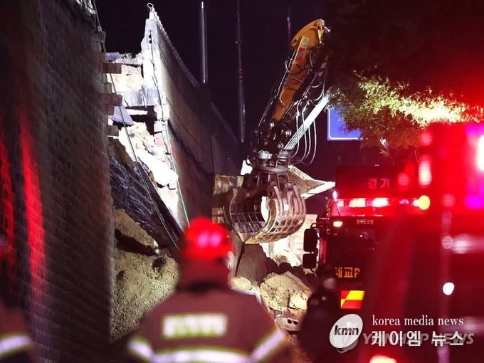 흙더미에 매몰된 차량이 1대인 것을 확인하고 굴착기를 동원해 구조 작업을 벌이고있다.<김영진기자>